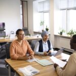 man-sitting-down-office-job-interview-desk-with-his-employers