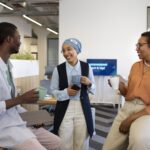 new-male-employee-conversing-with-female-colleagues-his-new-office-job